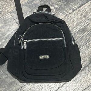 Classic Black Backpack with Durable Fabric and Silver Accents